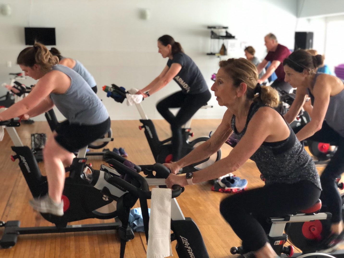 Spin class student cycling in a group