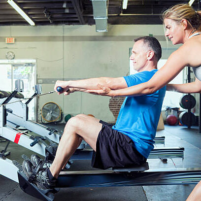 Personal trainer working with her client at a gym.